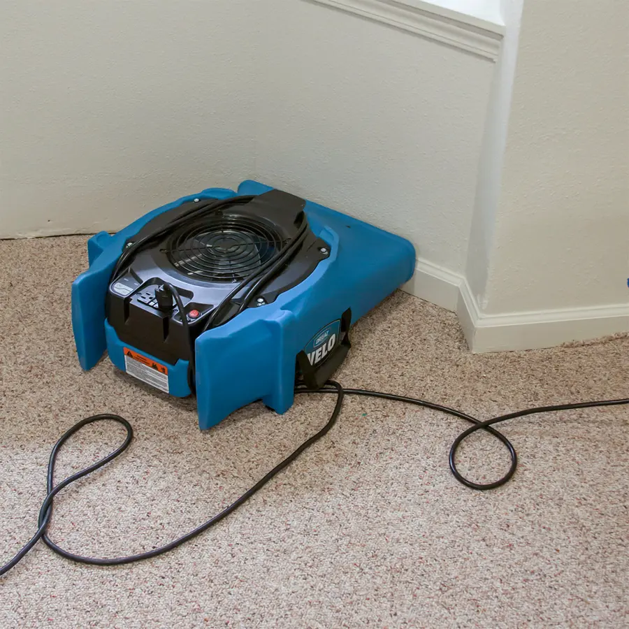 An air mover drying a tile floor in Bedford, TX